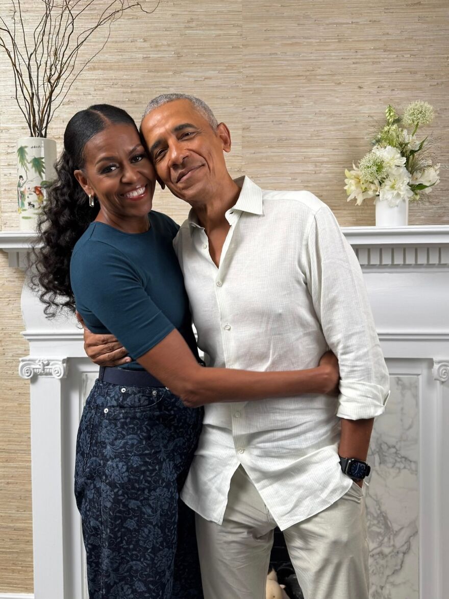 Michelle Obama and Barack Obama smiling and hugging closely in a warmly lit room, addressing marriage and divorce rumors. Michelle Obama and Barack Obama smiling and hugging closely in a warmly lit room, addressing marriage and divorce rumors.