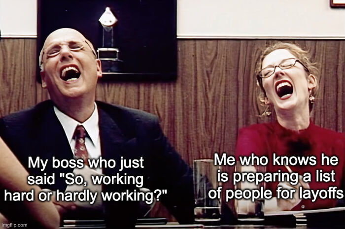 Two people laughing in an office setting with text about layoffs, illustrating funny memes about getting laid off.