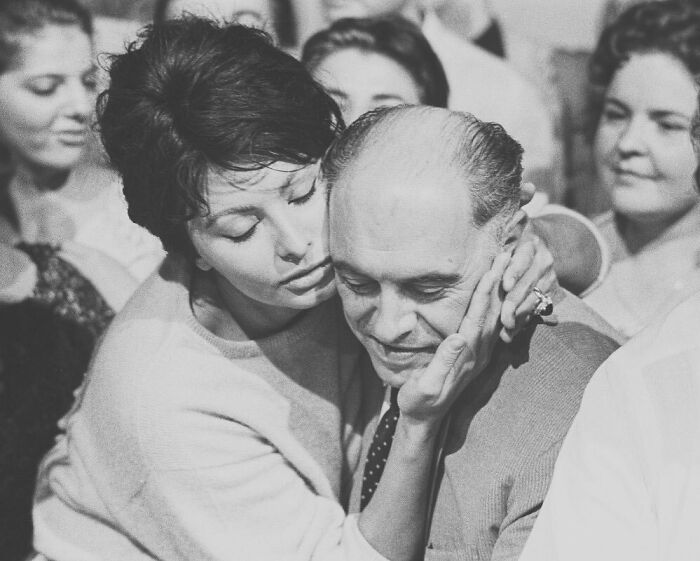 Sophia Loren gently embracing a man in a candid moment, highlighting Italian beauty and Hollywood legend charm.