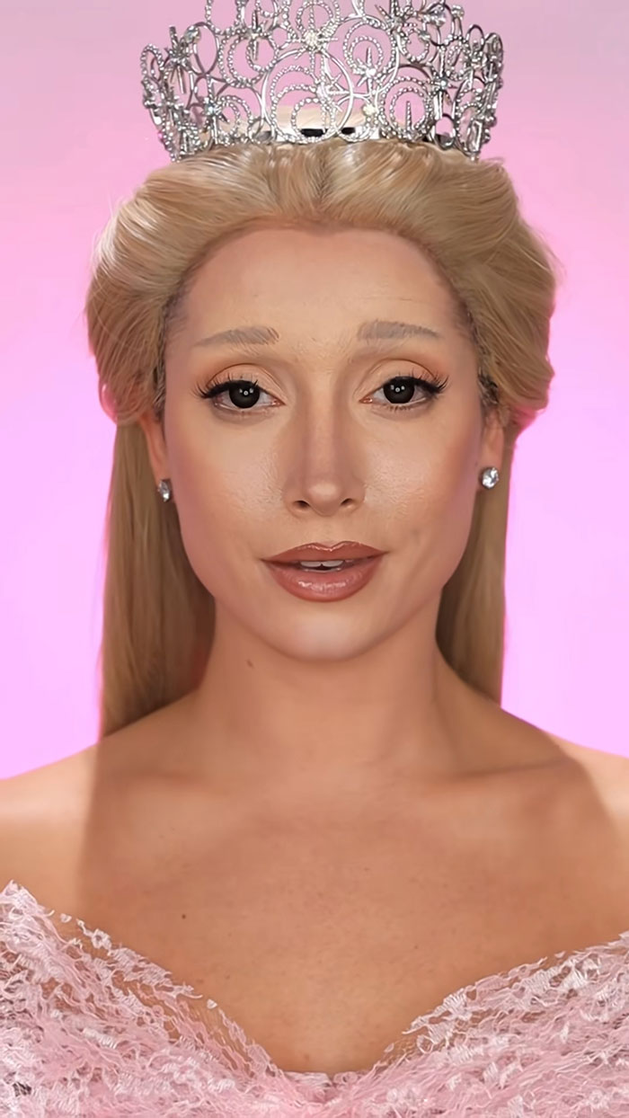 Woman with blonde hair wearing a detailed crown and pink lace dress showcasing amazing Halloween makeup artistry.