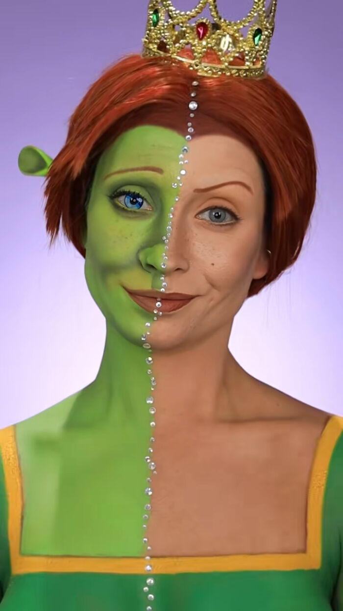 Half woman’s face painted green with Halloween makeup, wearing a crown and adorned with jewels down the center line.