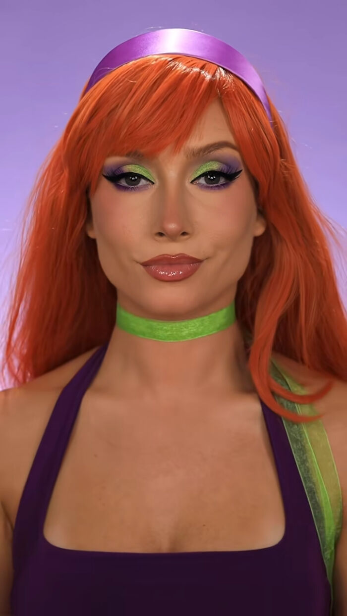 Creative Cliche showcasing amazing Halloween makeup with vibrant colors and detailed eye artistry on a purple and green costume.