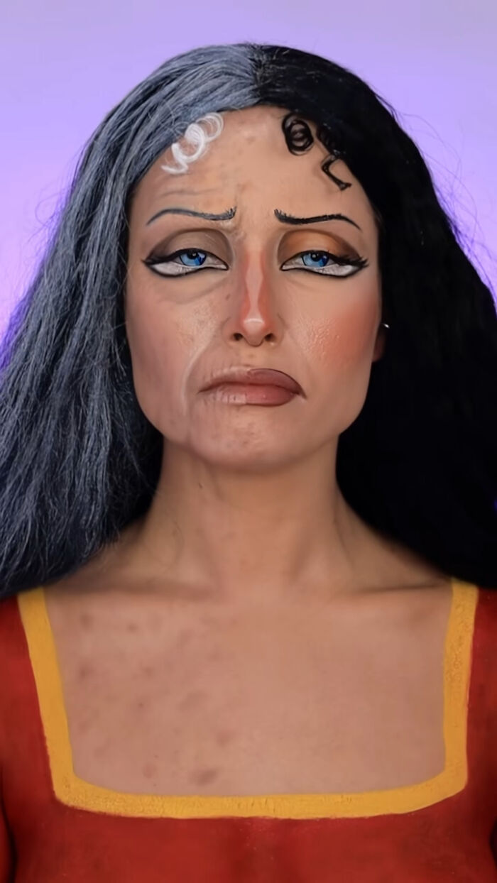 Woman with creative Halloween makeup showing a split gray and black hair look and detailed facial effects on a purple background