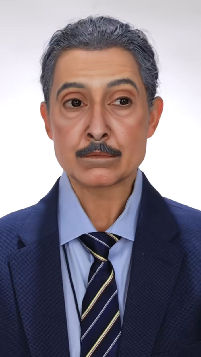 Man in a suit showcasing creative Halloween makeup with realistic aging effects and gray hair transformation.