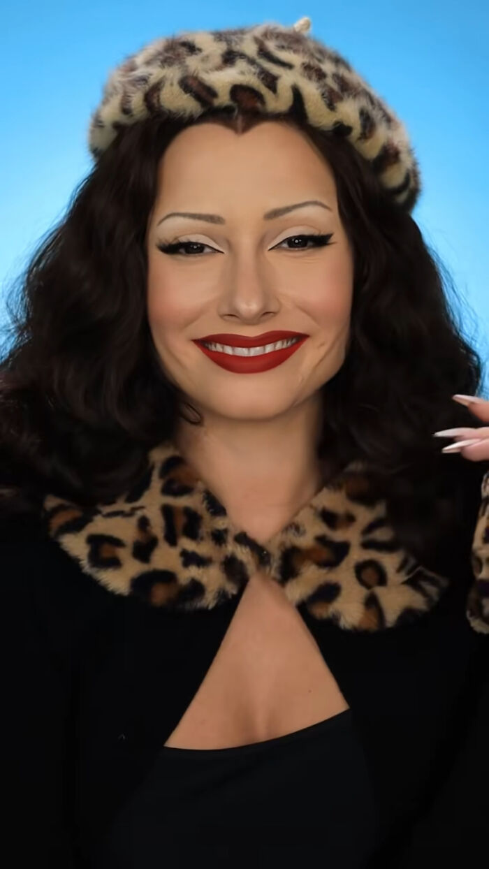 Creative Cliche wearing leopard print beret and collar, showcasing amazing Halloween makeup with bold red lips and winged eyeliner.