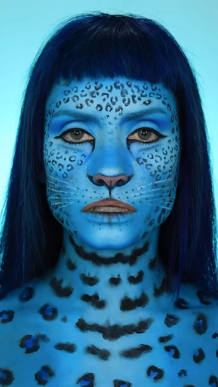 Blue leopard Halloween makeup covering face and upper chest by creator Creative Cliche in detailed animal design.