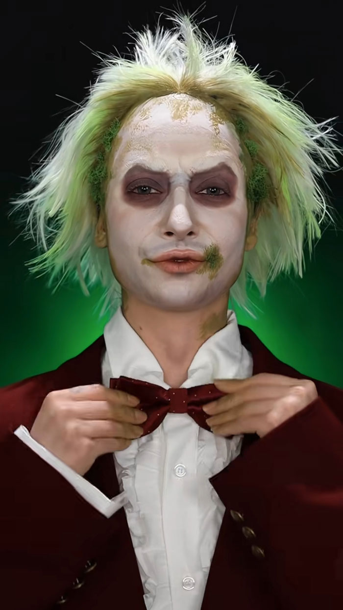 Creative Cliche Halloween makeup featuring detailed face paint, green hair accents, and costume with bow tie and ruffled shirt.