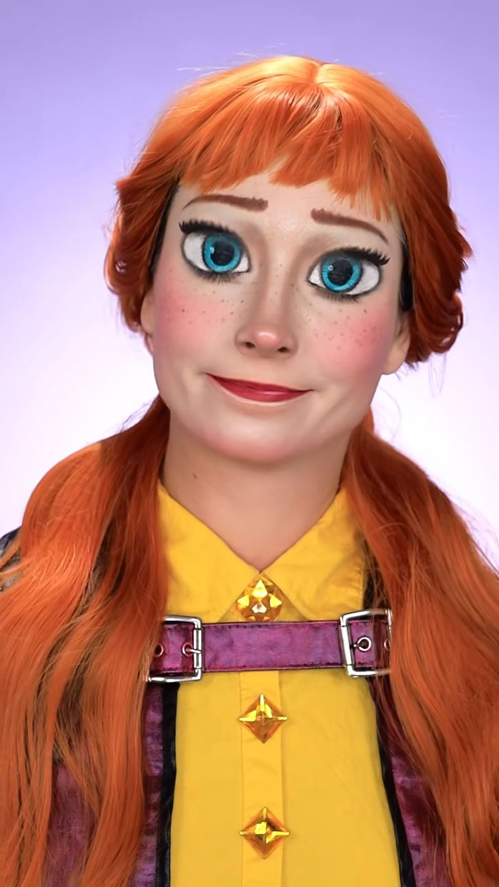 Creative Cliche Halloween makeup with detailed cartoon-style face paint and bright orange hair in a styled costume.