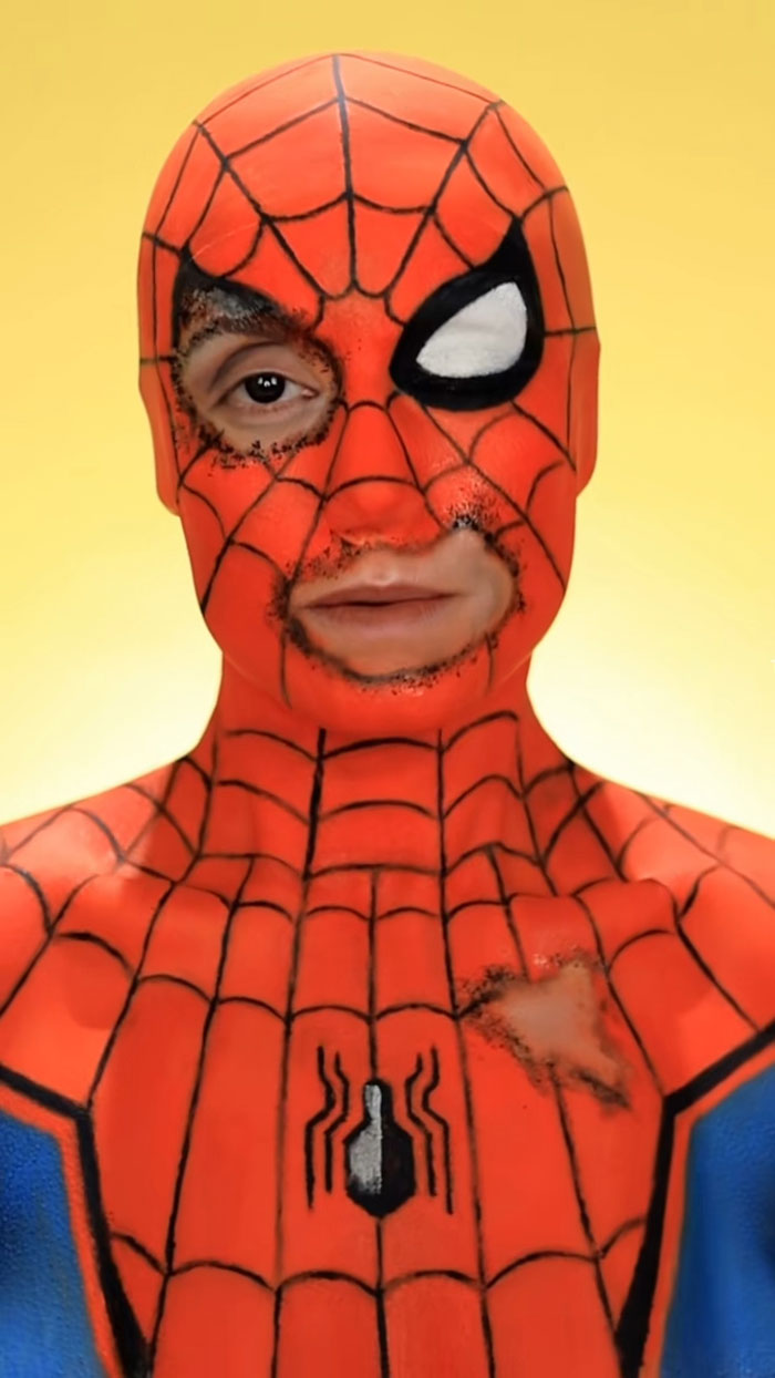 Spiderman inspired Halloween makeup by Creator Creative Cliche showing detailed face and chest paint with web patterns.