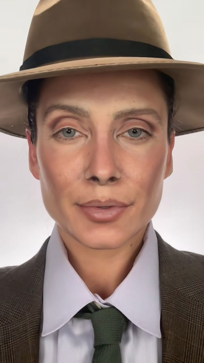 Person wearing Halloween makeup with a brown hat, suit jacket, white shirt, and green tie showcasing creative Halloween makeup.