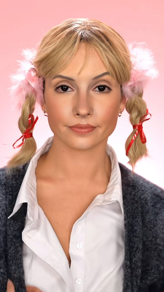 Young woman with braided hair and red ribbons showcasing creative Halloween makeup by Creator Creative Cliche.