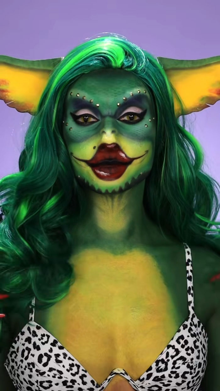 Creative Cliche's amazing Halloween makeup with green goblin face paint, yellow-green shading, and dramatic eye details.