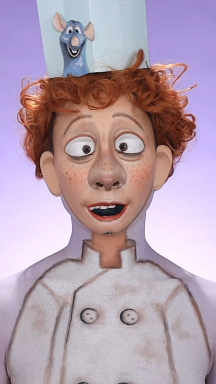 Creative Halloween makeup transforming a person into a cartoon chef with red hair and a rat on their hat.