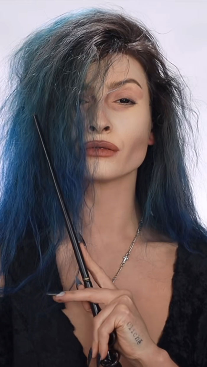 Creative Cliche showcasing amazing Halloween makeup with blue hair and a wand, highlighting spooky and artistic style details.