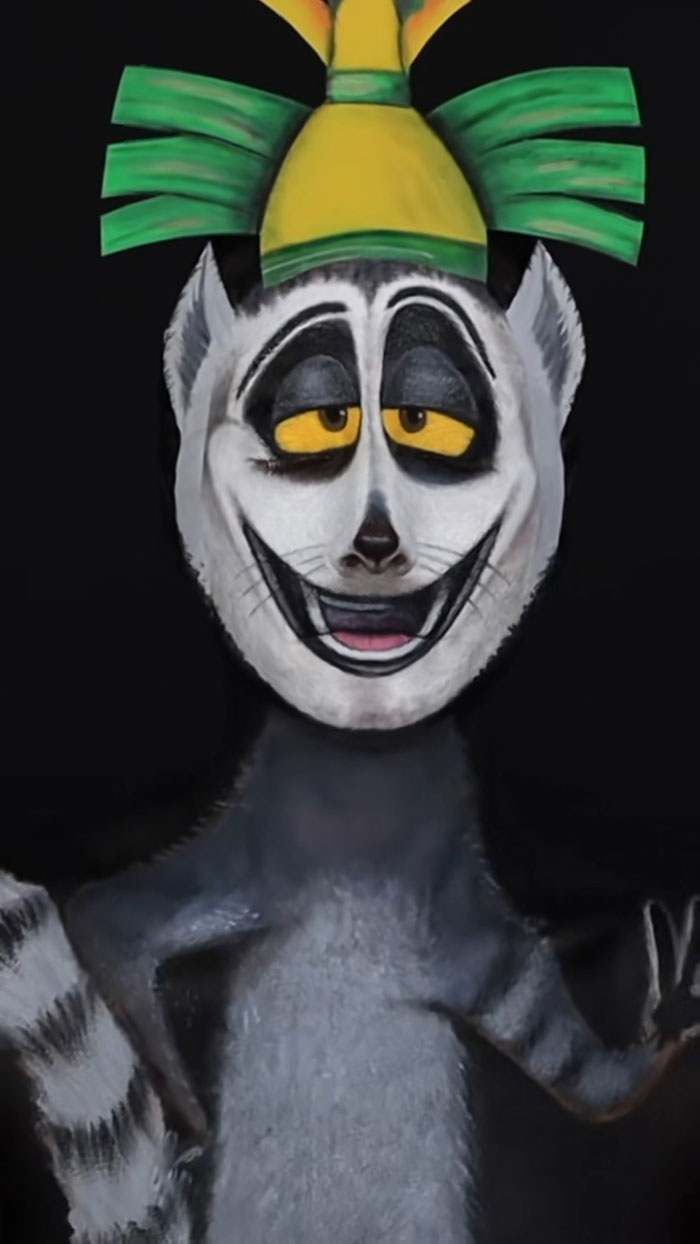 Creative Cliche Halloween makeup of a whimsical character with green and yellow headpiece and detailed facial paint.