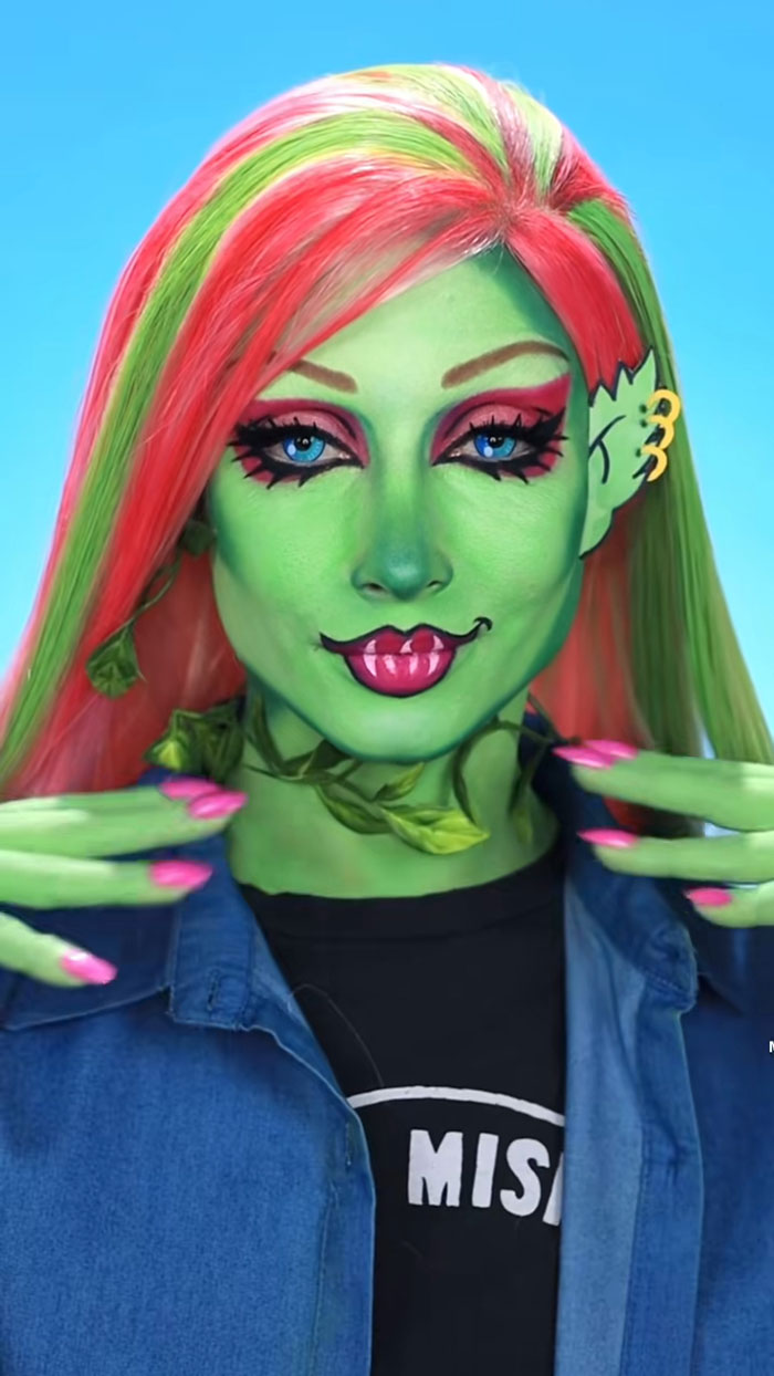 Creative Cliche showcasing amazing Halloween makeup with vibrant green face paint, pink eyeshadow, and colorful hair details.