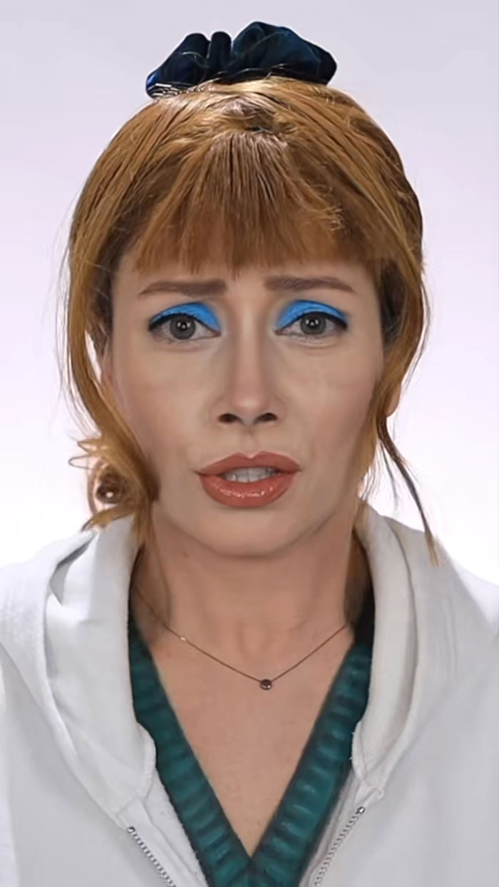 Woman with creative Halloween makeup featuring bold blue eyeshadow and natural lips, showcasing amazing Halloween makeup art.