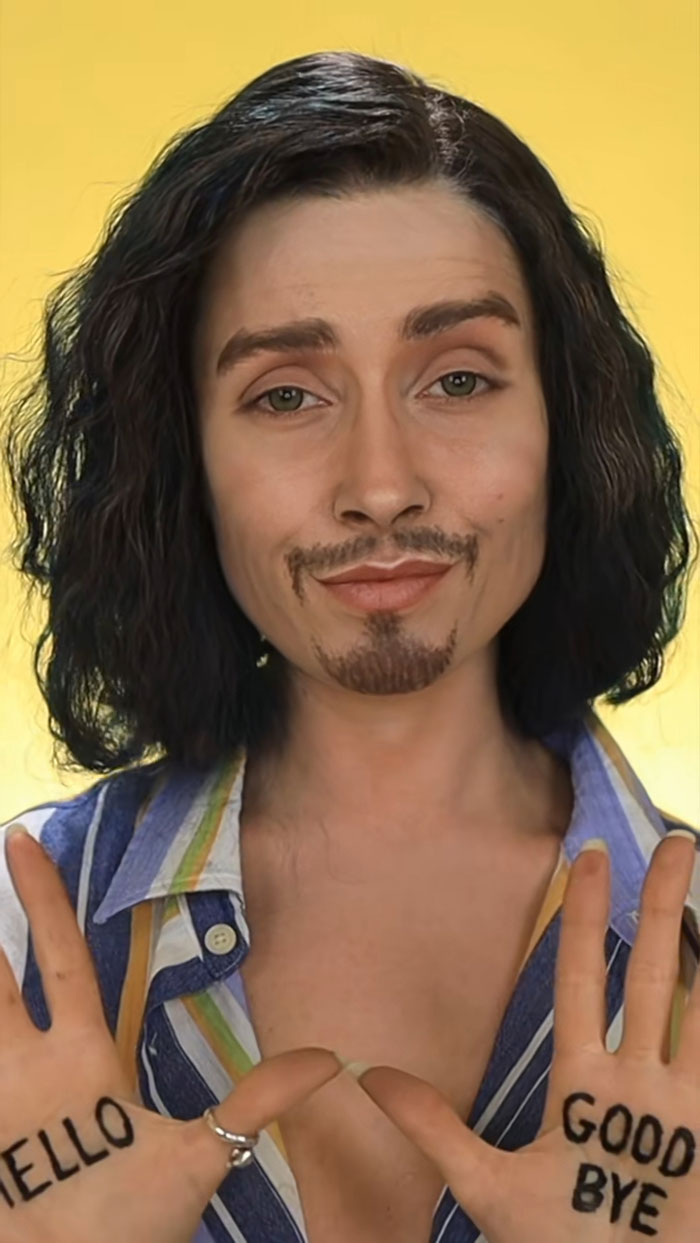 Person with creative Halloween makeup showing hand signs with hello and goodbye written on palms against yellow background