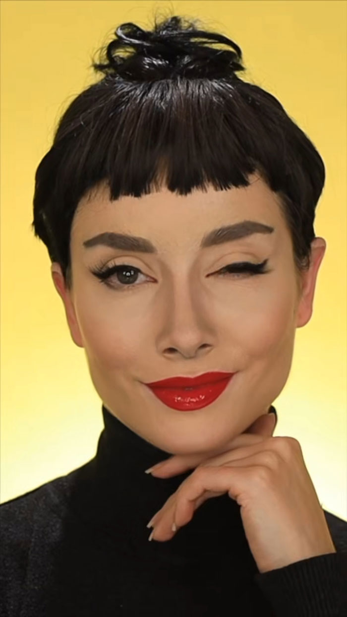 Creative Cliche showcasing stunning Halloween makeup with bold red lips and dramatic eye makeup against a yellow background.