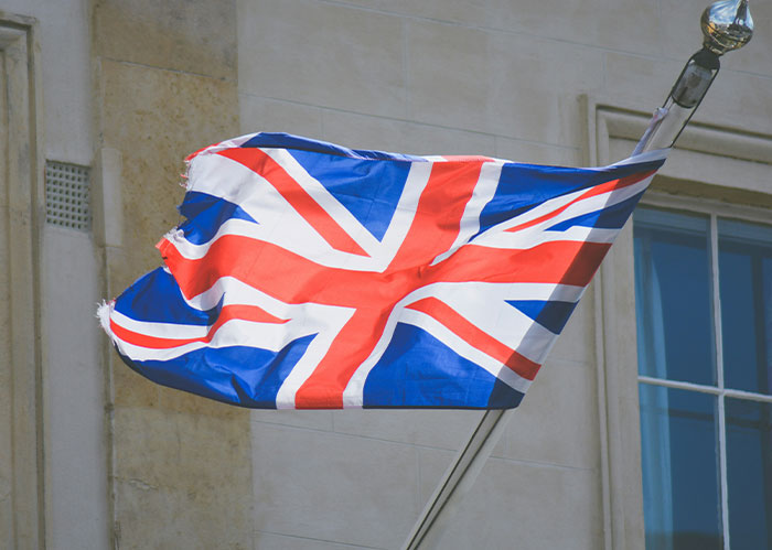 Union Jack flag waving outside a building, relating to Rihanna slapped him shocking celebrity facts and new pics.