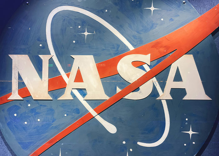 NASA logo painted on a blue background with stars, emphasizing Rihanna slapped him fascinating facts theme.