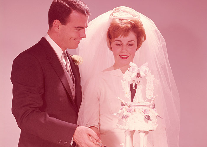 Bride and groom cutting a wedding cake together with vintage style and Rihanna slapped him concept inspiration.