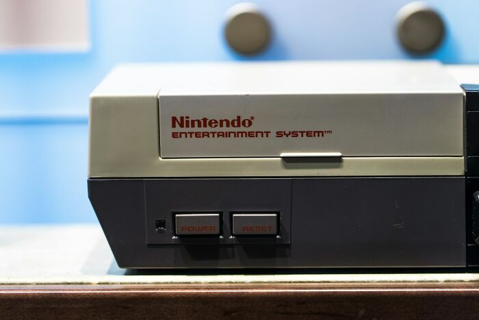 Close-up of a retro Nintendo Entertainment System console showcasing classic brand design and power buttons.