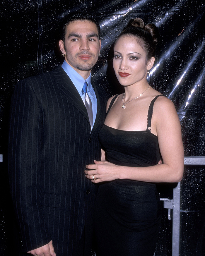 Jennifer Lopez and her ex-husband posing together at a formal event, related to cheating accusations.