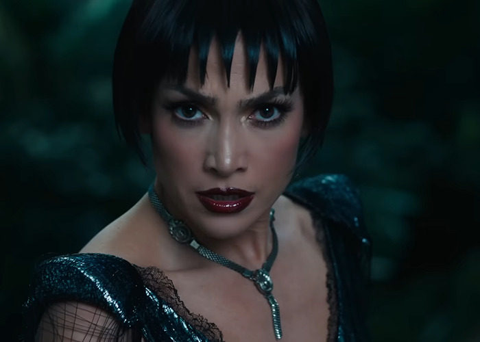 Jennifer Lopez in a dramatic look with dark lipstick and bold eyeshadow, capturing fan rage and confusion on red carpet.