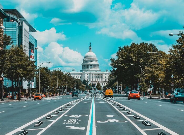 Wide avenue leading to the Capitol building in Washington DC under a blue sky, illustrating common truths mistaken as propaganda.