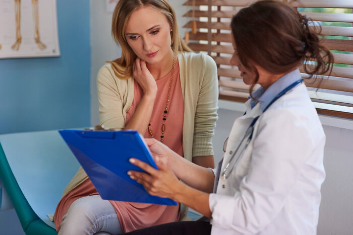Patient in a medical consultation with doctor, discussing symptoms often mistaken for anxiety but linked to other issues.