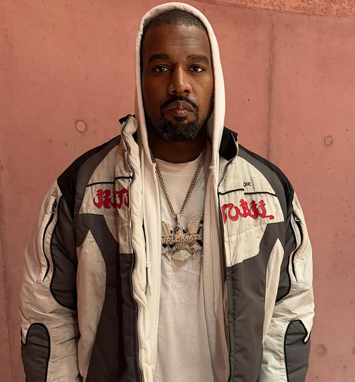 Kanye West wearing a hooded jacket and chain, symbolizing his warning about daughter North&rsquo;s online life concerns.