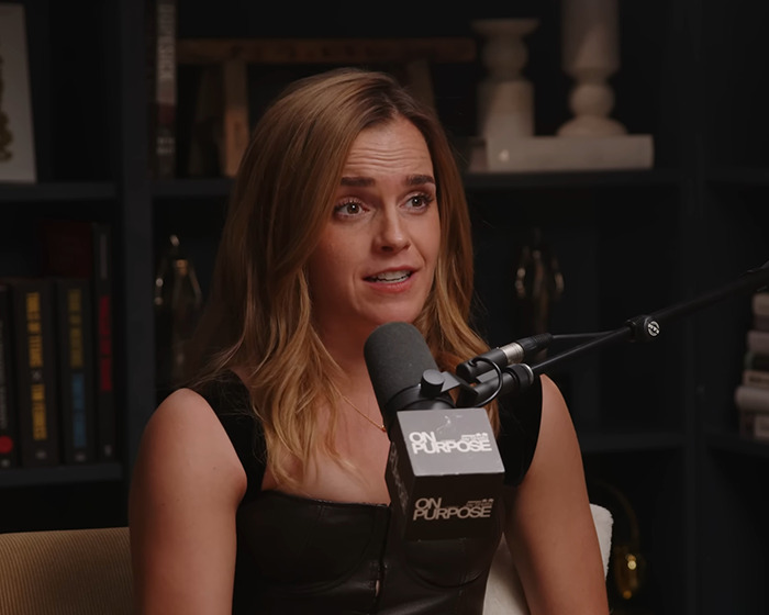 Keira Knightley speaking into a podcast microphone during a discussion about Harry Potter casting backlash.