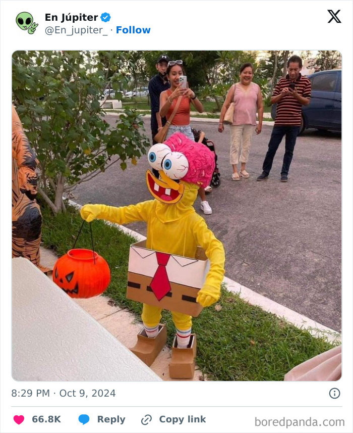 Child in colorful animated character costume holding pumpkin bucket outdoors with adults watching, showcasing kids Halloween costume ideas.