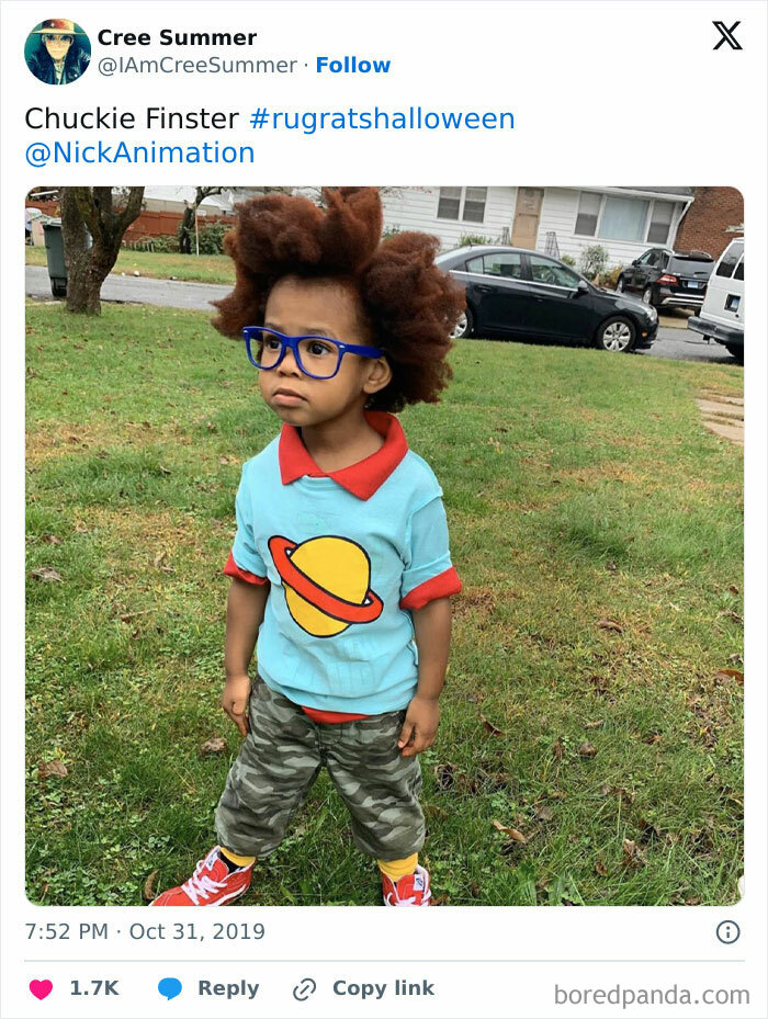 Child dressed as Chuckie Finster in creative kids Halloween costume ideas with colorful outfit and blue glasses outdoors.