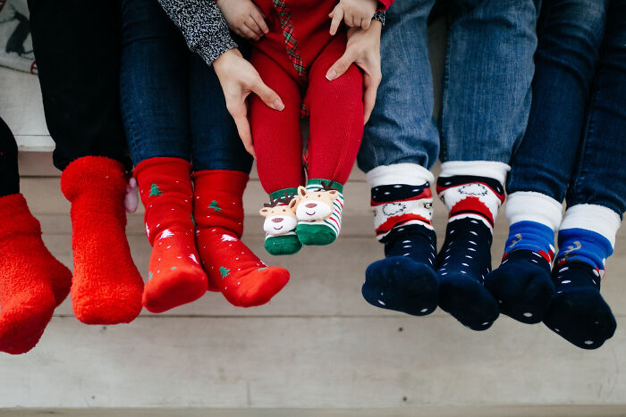Children wearing festive and colorful socks, showcasing random things people did as kids that weren’t exactly normal.