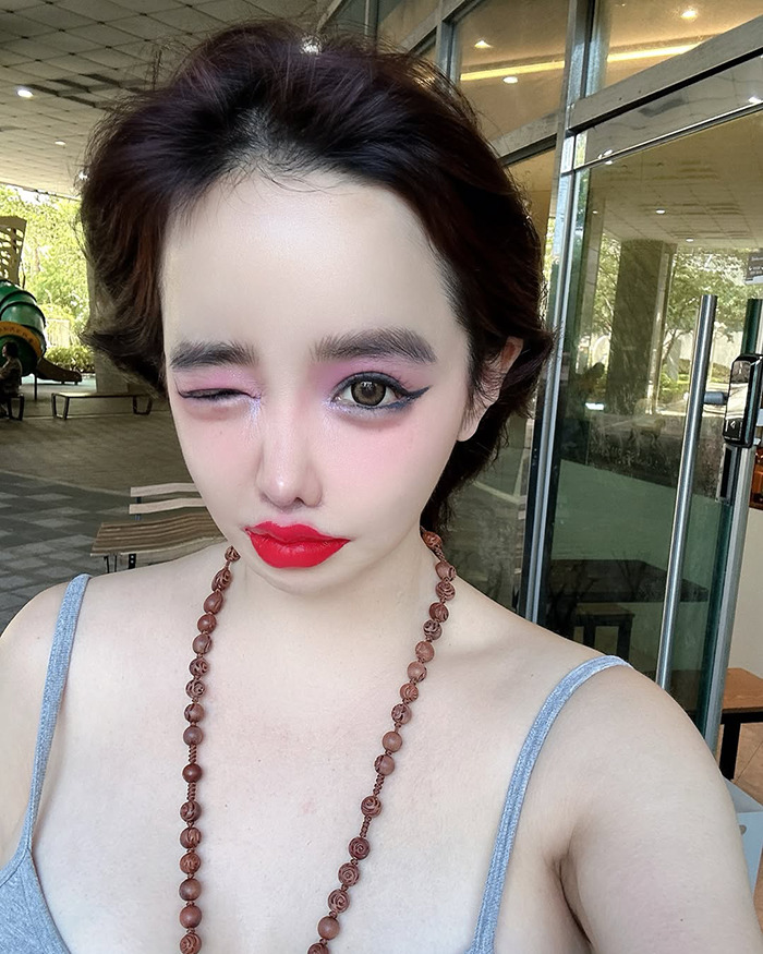 K-Pop icon Park Bom with bold makeup and a dramatic look, highlighting her drastic plastic surgery transformation.