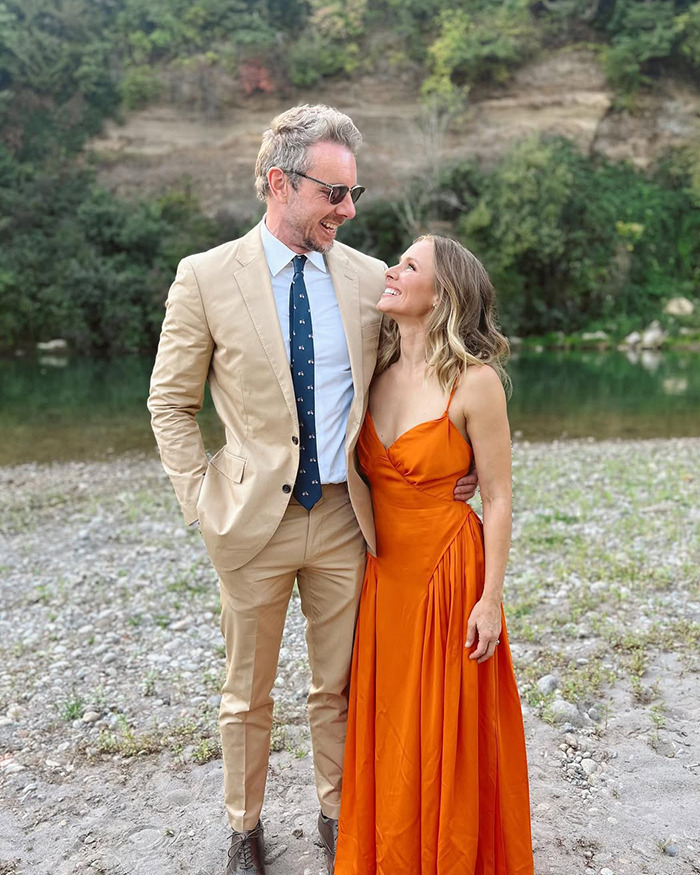 Kristen Bell and Dax Shepard smiling outdoors by a river, highlighting their marriage and blackout fights insider reports.