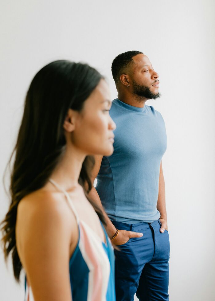Couple standing apart looking serious, representing how spouses changed after the wedding and ignored red flags.