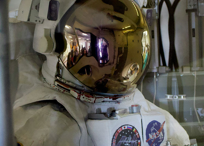 Astronaut suit with reflective helmet inside a museum display, highlighting facts people learned embarrassingly late about steak from cows.