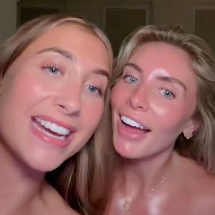 Two smiling women with blonde hair and blue eyes posing closely in a casual indoor setting for fame discussion.