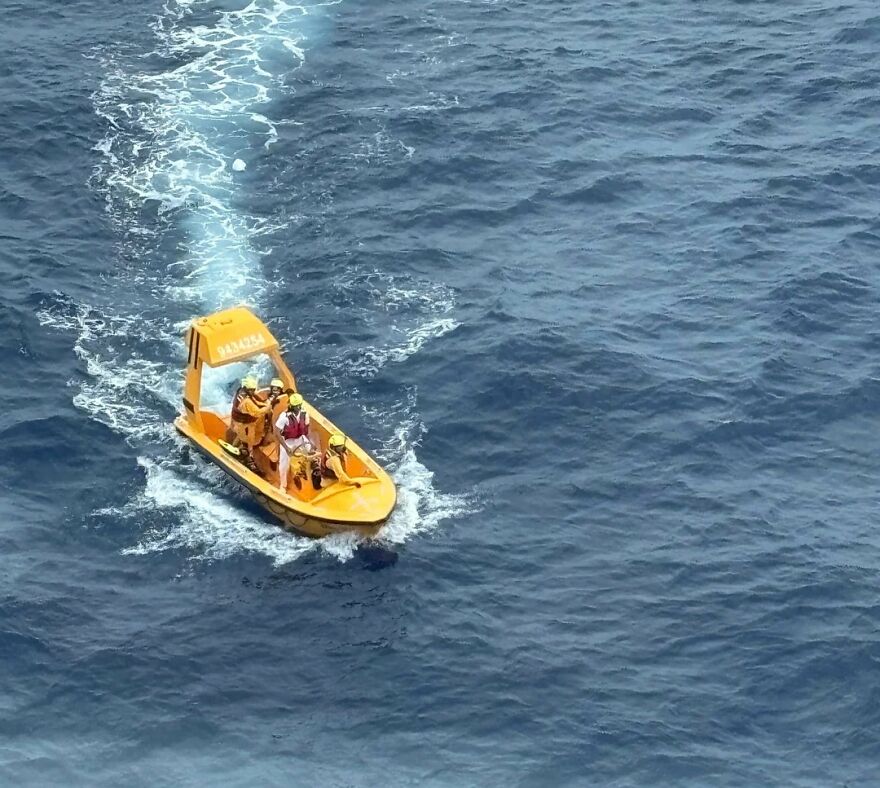 Rescue team in a small yellow boat navigating ocean waters after a girl's terrifying plunge from a cruise ship exposed.
