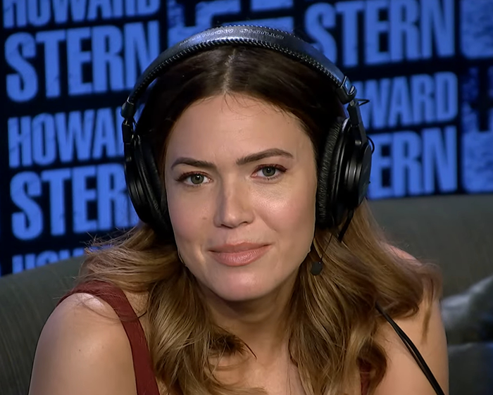Mandy Moore in a radio studio wearing headphones, showcasing her new unrecognizable look that baffles fans.
