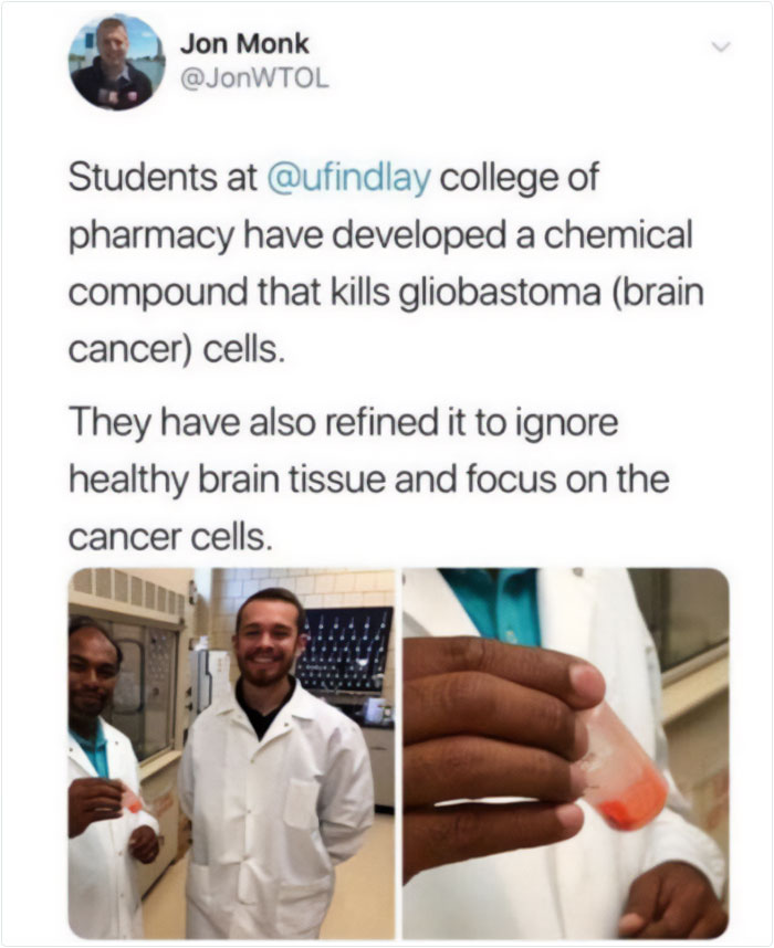 Medical students in lab coats holding a chemical compound targeting brain cancer cells in a pharmacy research setting