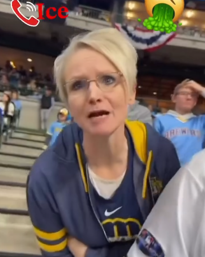 Woman in a baseball stadium wearing glasses and team apparel during a viral incident involving a racist rant at an MLB game.