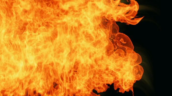 Bright orange and yellow flames engulfing a dark background, illustrating intense heat and near-death experiences theme.