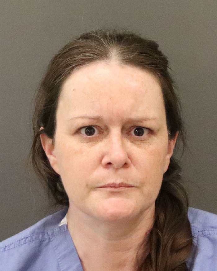 Mugshot of a woman involved in a haunting 911 call after confessing to taking her teen son's life.