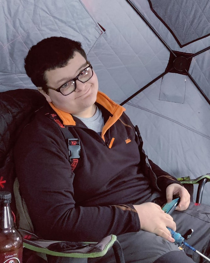 Teen boy wearing glasses sitting in a chair inside a tent, related to haunting 911 call and mom confession story.