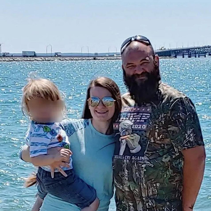 Family posing by a sunny waterfront wearing casual clothes, linked to Mormons raising funds for Michigan church incident.