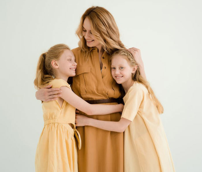 Twins hugging their stepmom and mother, expressing desire to include stepmom in group Halloween costume plans.